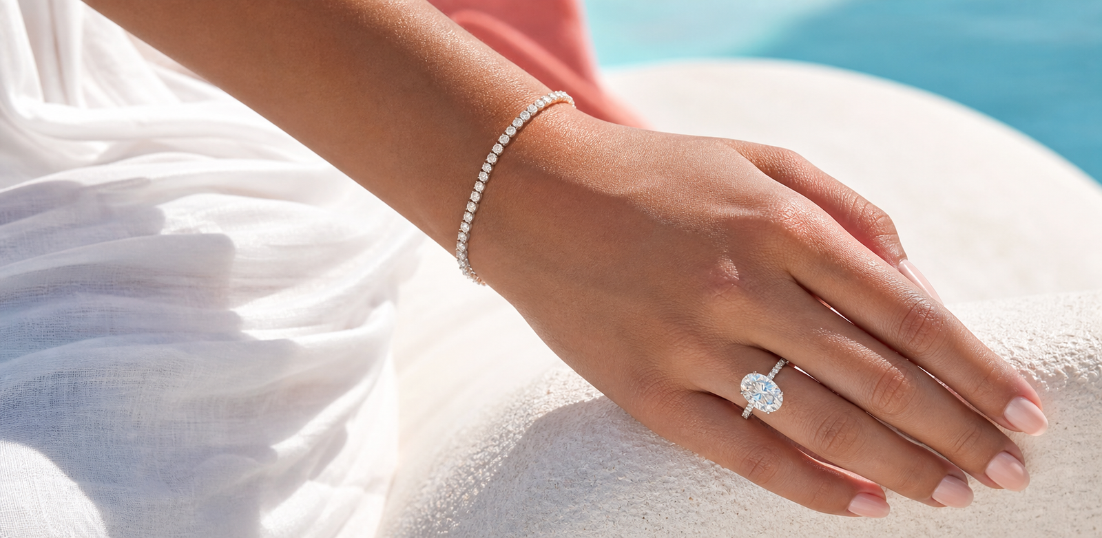 Model wearing a diamond engagement ring and tennis bracelets